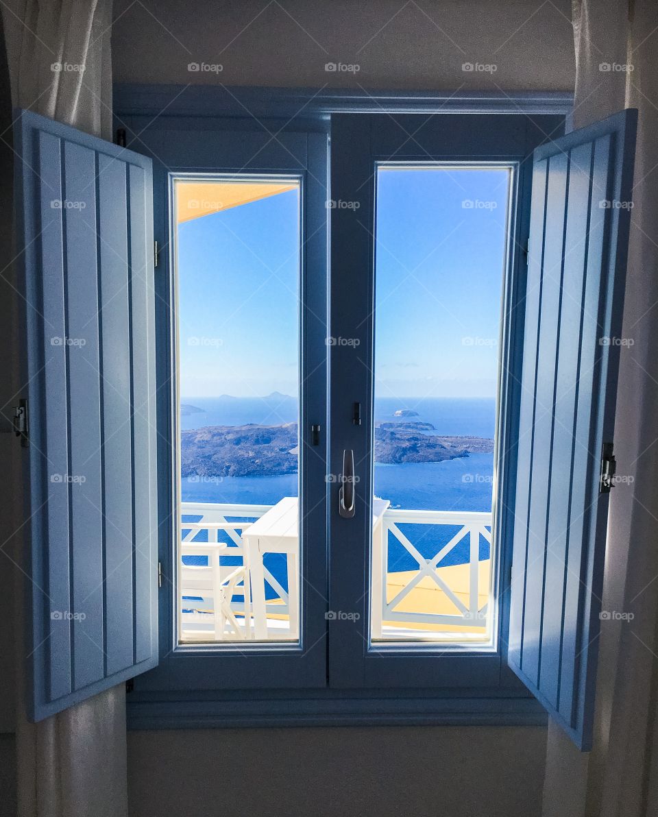 Window with view overlooking the sea and volcano 