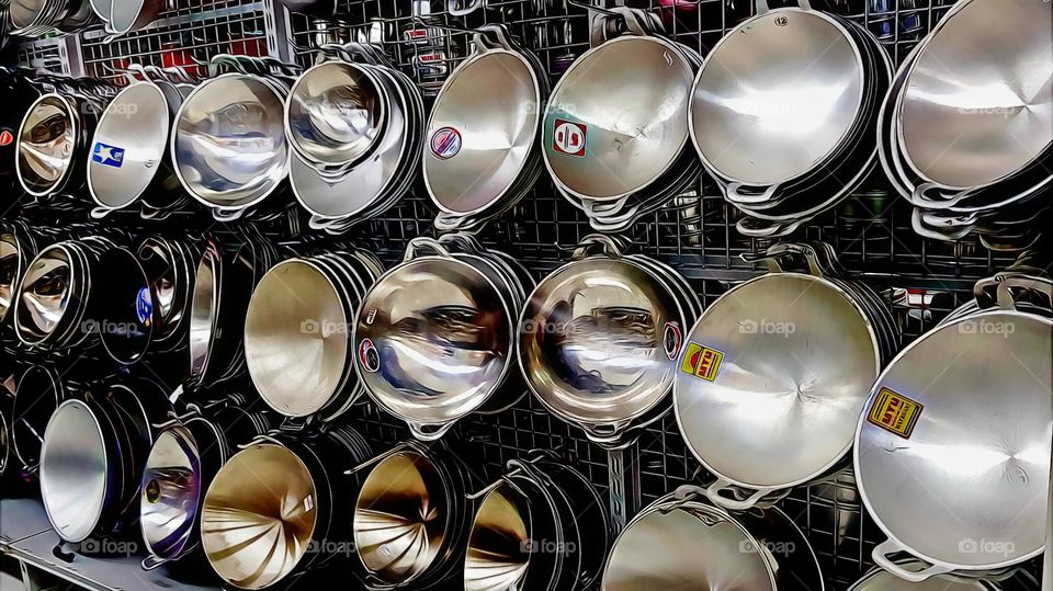 metal pans on display on shelves, household products, ready for sale, alumunium pans, kitchen product, cooking utensils, various size, various cuisines, heat resistant, rust resistant, corroson resistant,