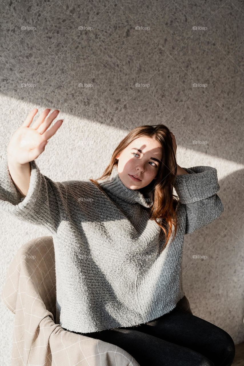 creative woman portrait indoors with light and shadow play