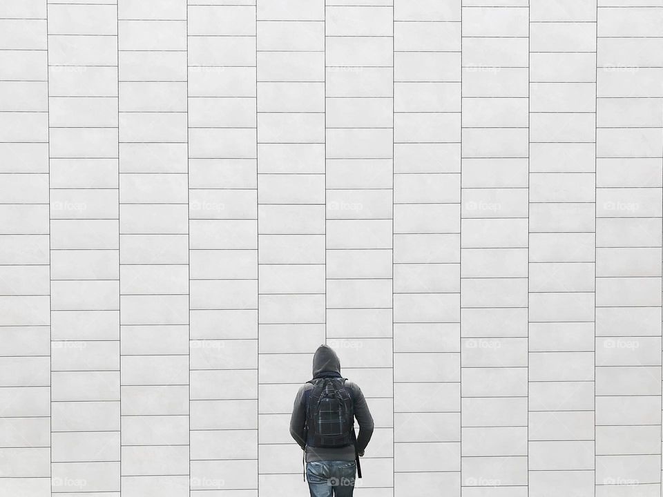 Walking in front of a geometric wall 