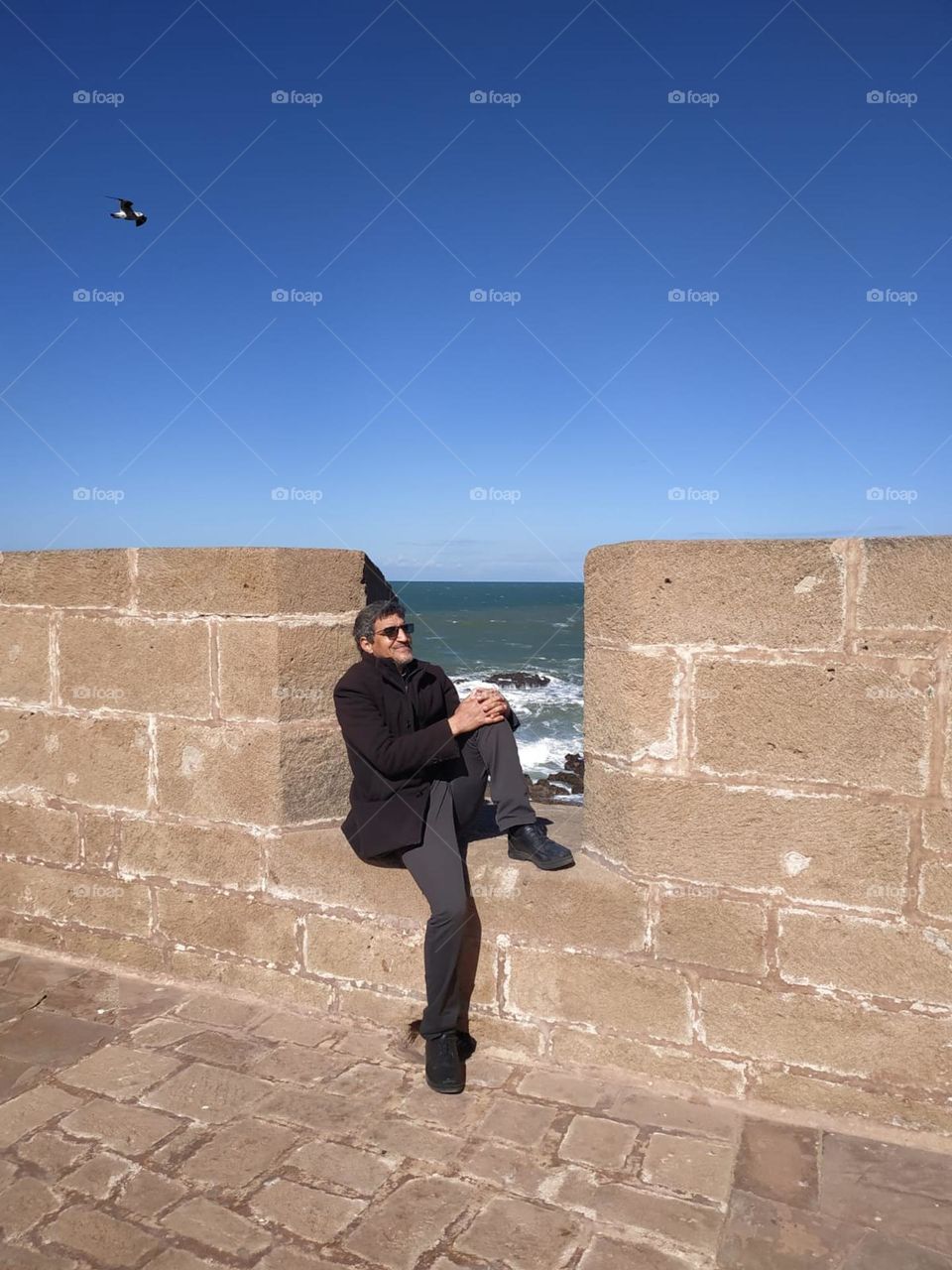 Im sitting on an ancient wall  at essaouira city in Morocco.