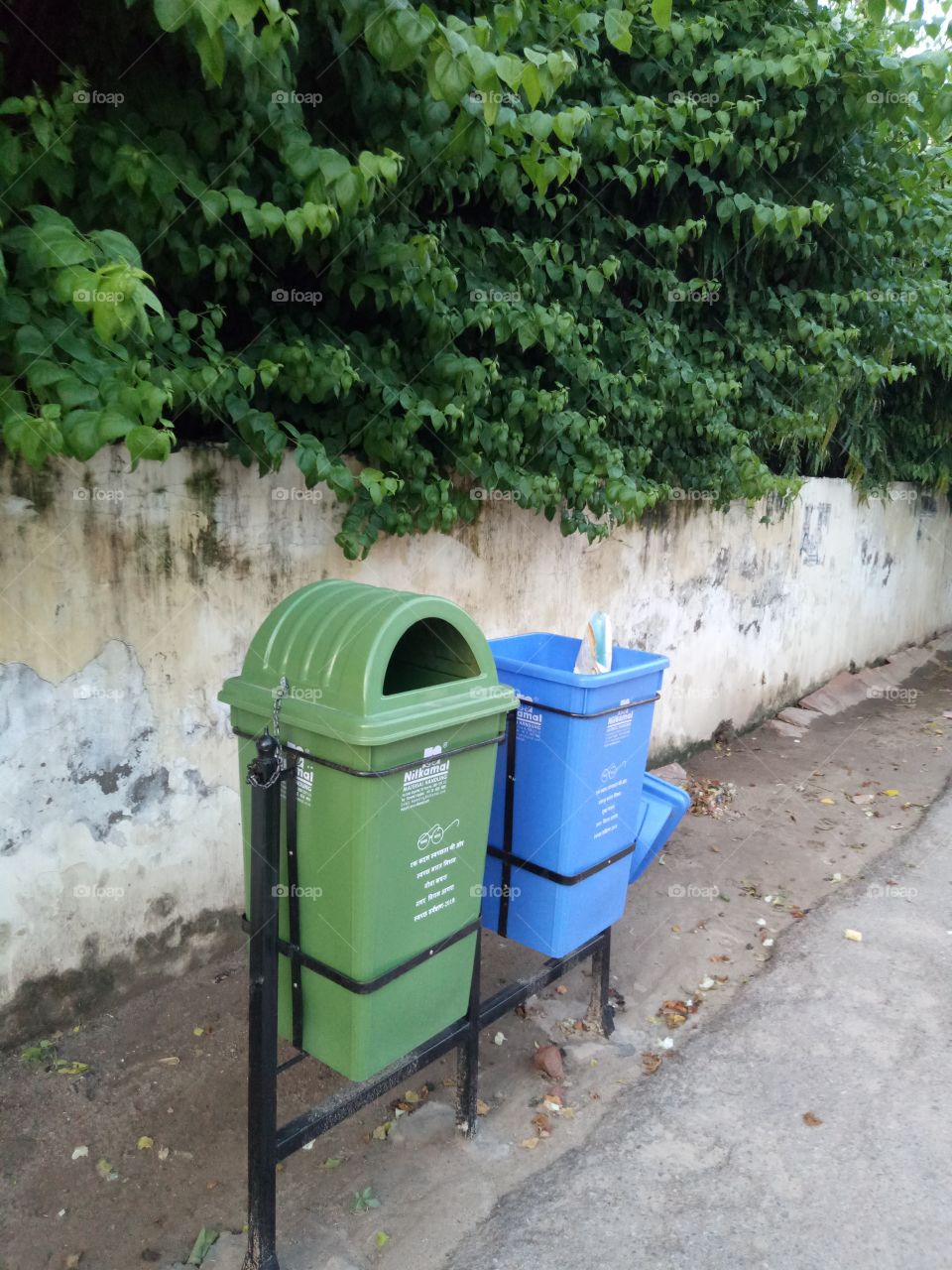 two garbage bins are on roadside