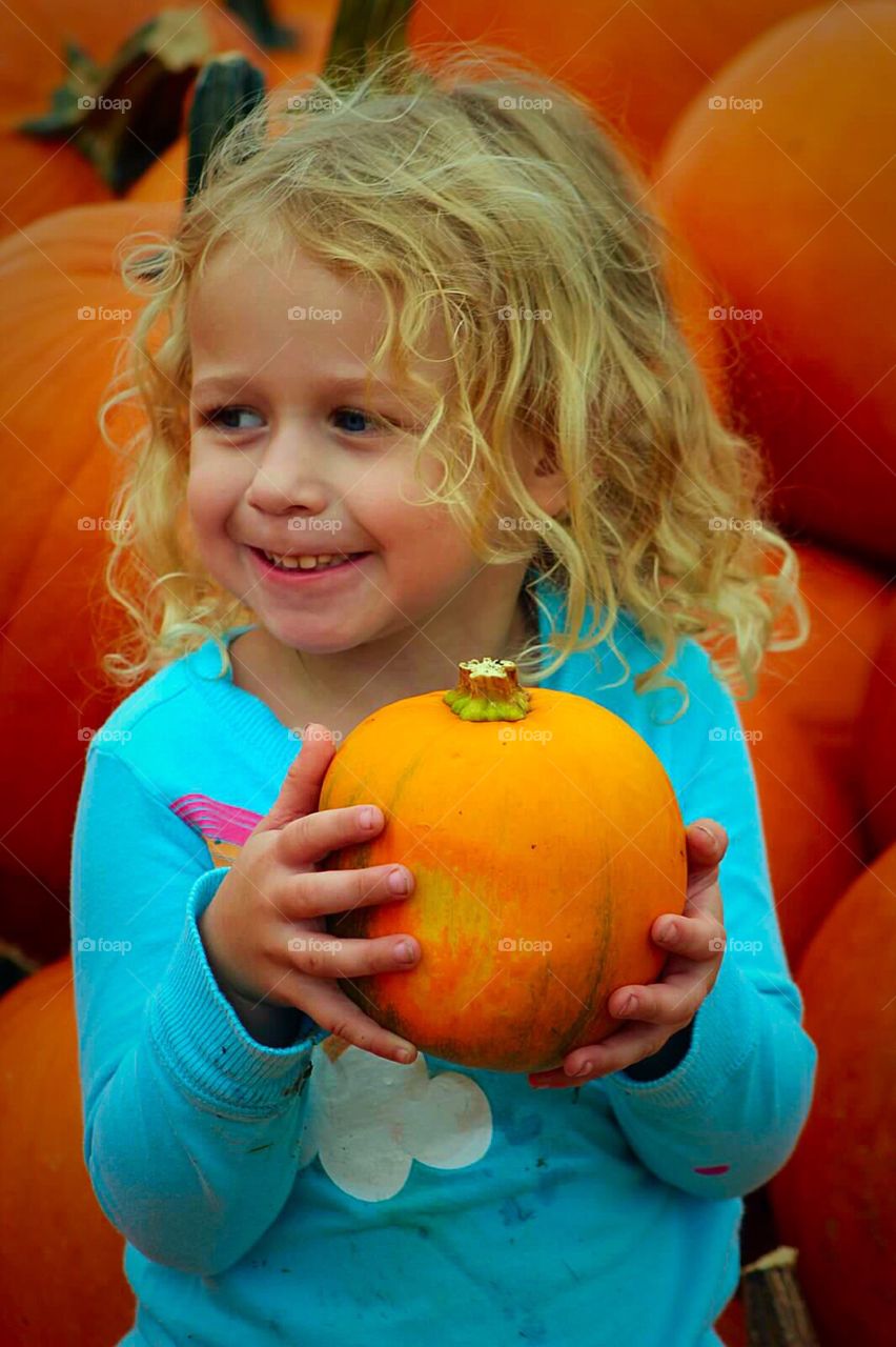 Close-up of a girl holding pumpkin