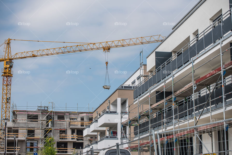 view of the construction site, scaffolding and crane