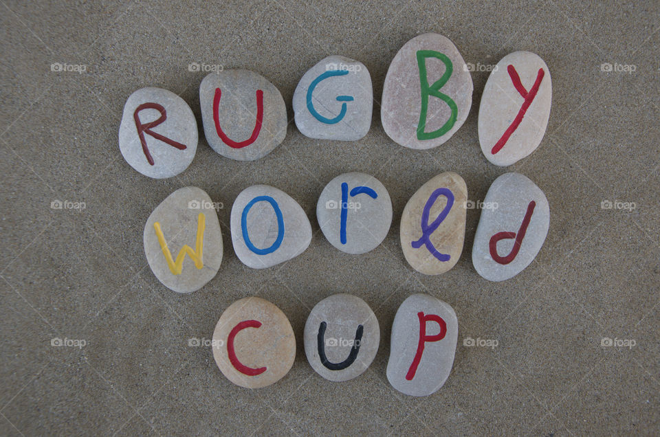 Rugby World Cup on stones. Rugby World Cup souvenir on colored stones