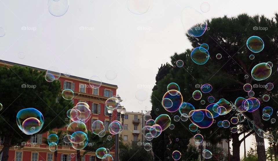 Bubbles in foreground of view of Place Massena in Nice, France.