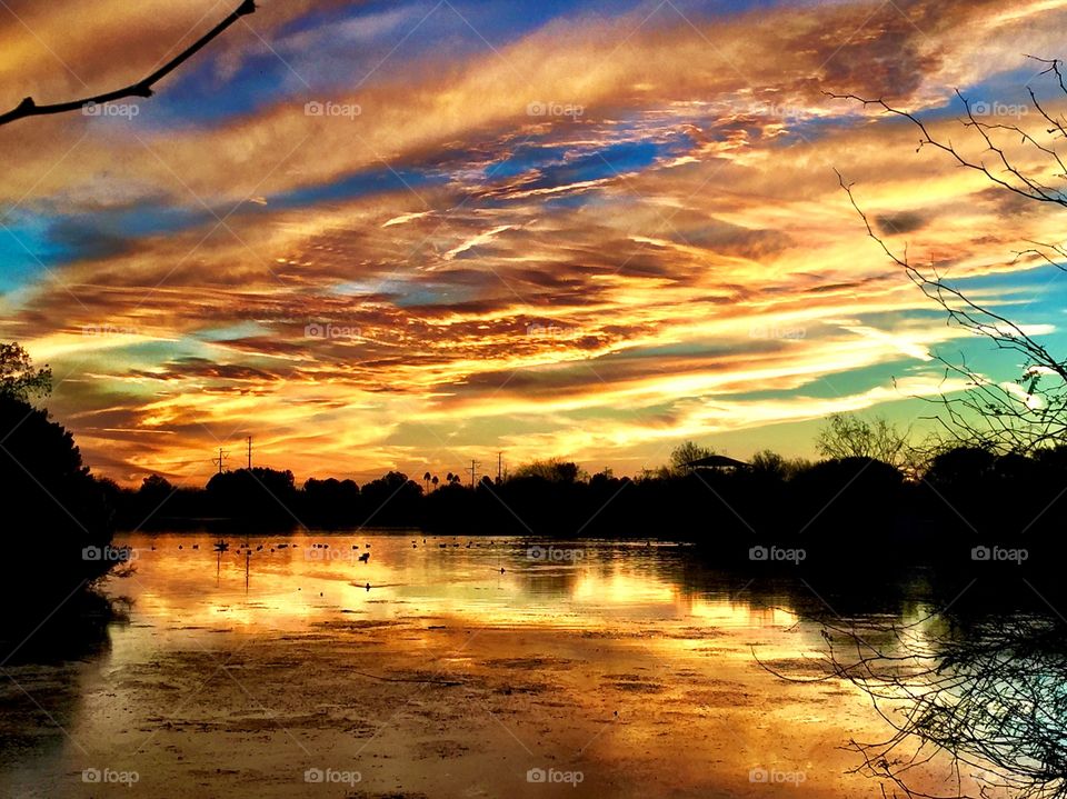 Scenic view of lake against dramatic sky