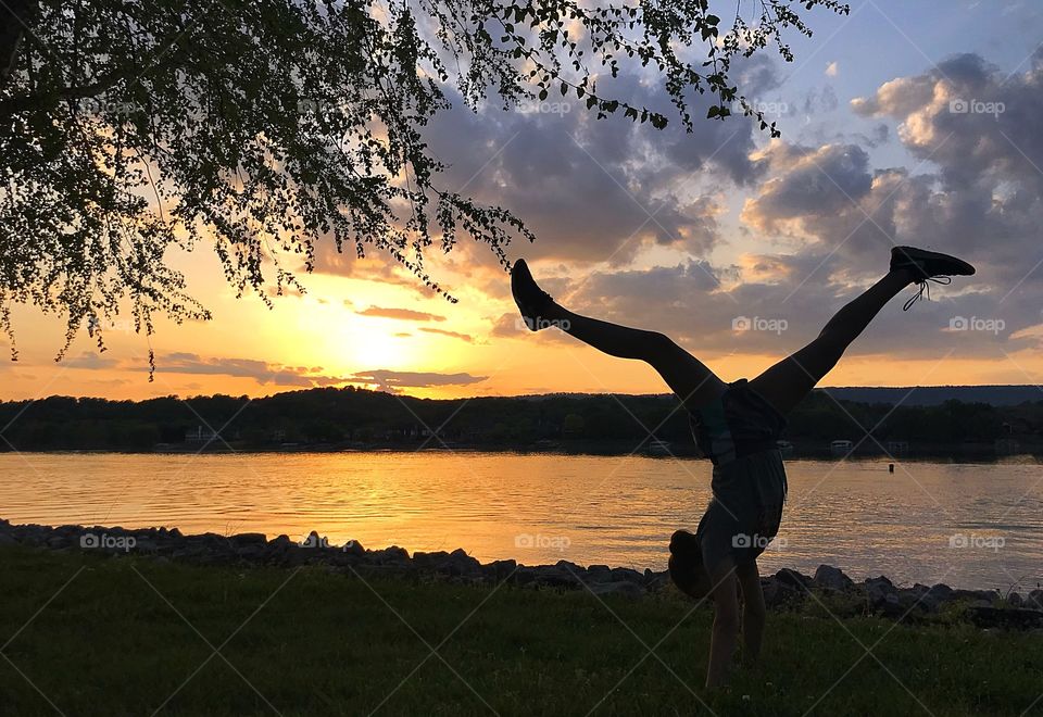 Yoga by the river at sunset