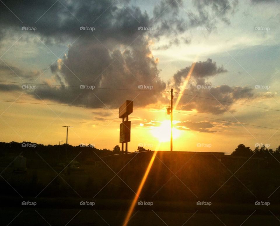 Sun Rays shining between the street sign
