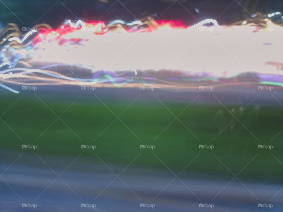 Light painting created through various light sources residents
vehicles headlight to brake light street lamp police light. Long exposure in night traffic on road. Blurred lights captured while driving at
night