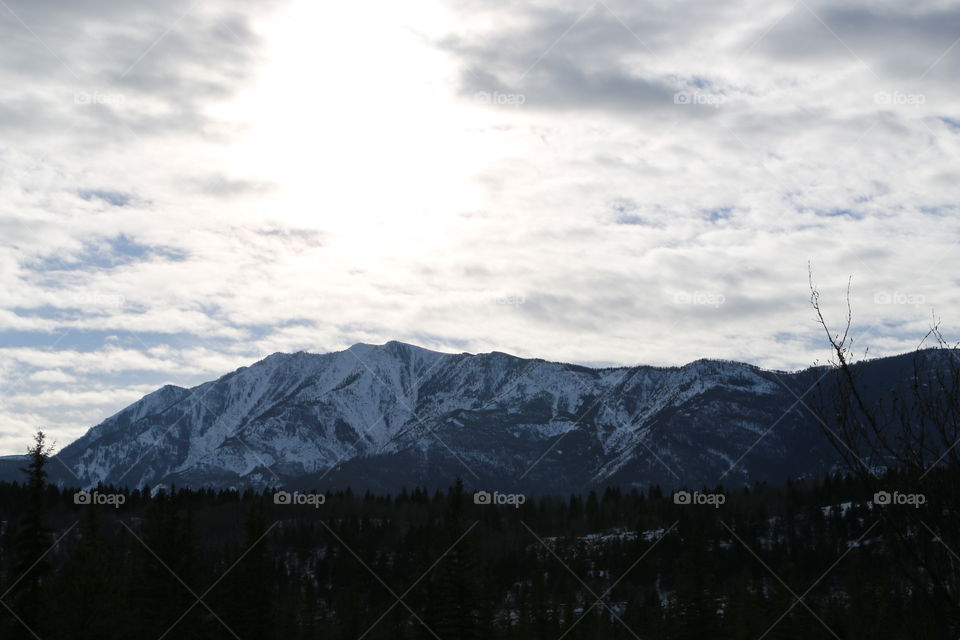 Winter's afternoon sun sinking over the mountains near Invermere