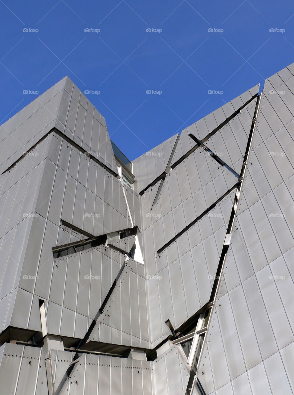 Low angle view of built structure of the Jewish Museum Berlin against clear sky.