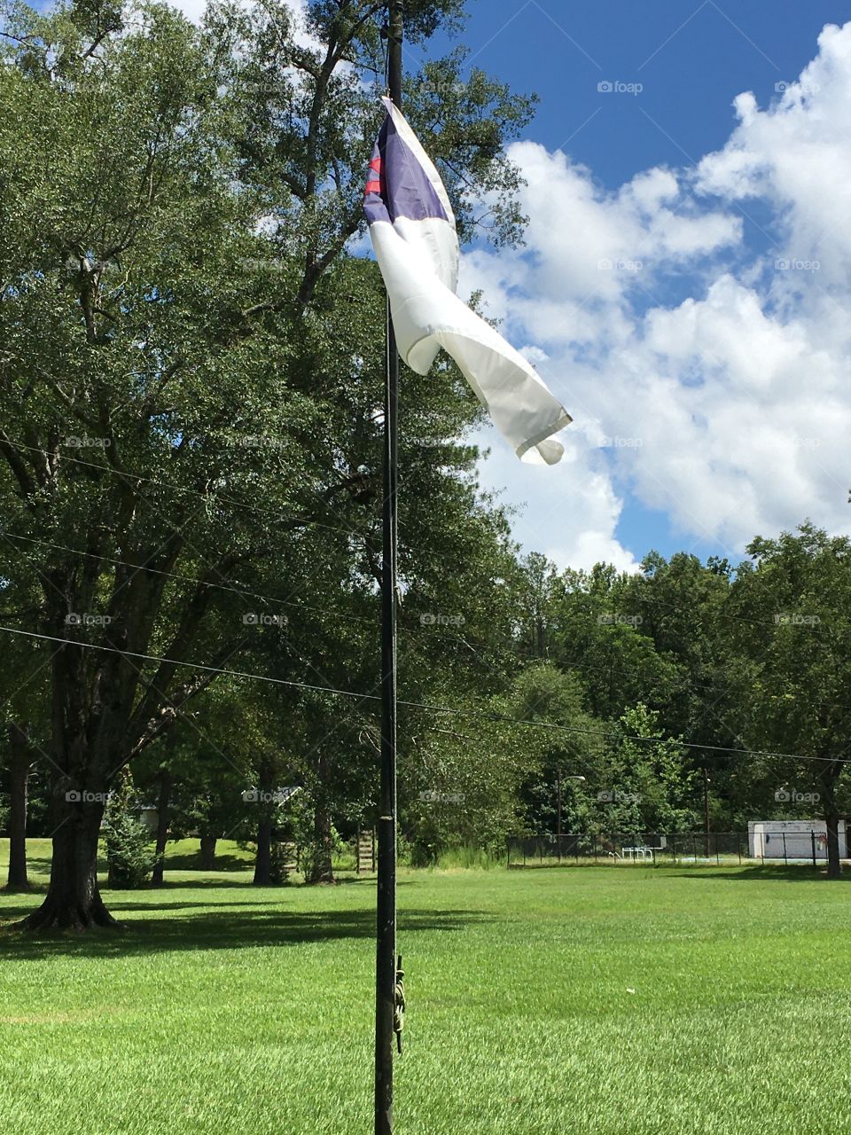 Flagpole waving gently in the summer breeze 