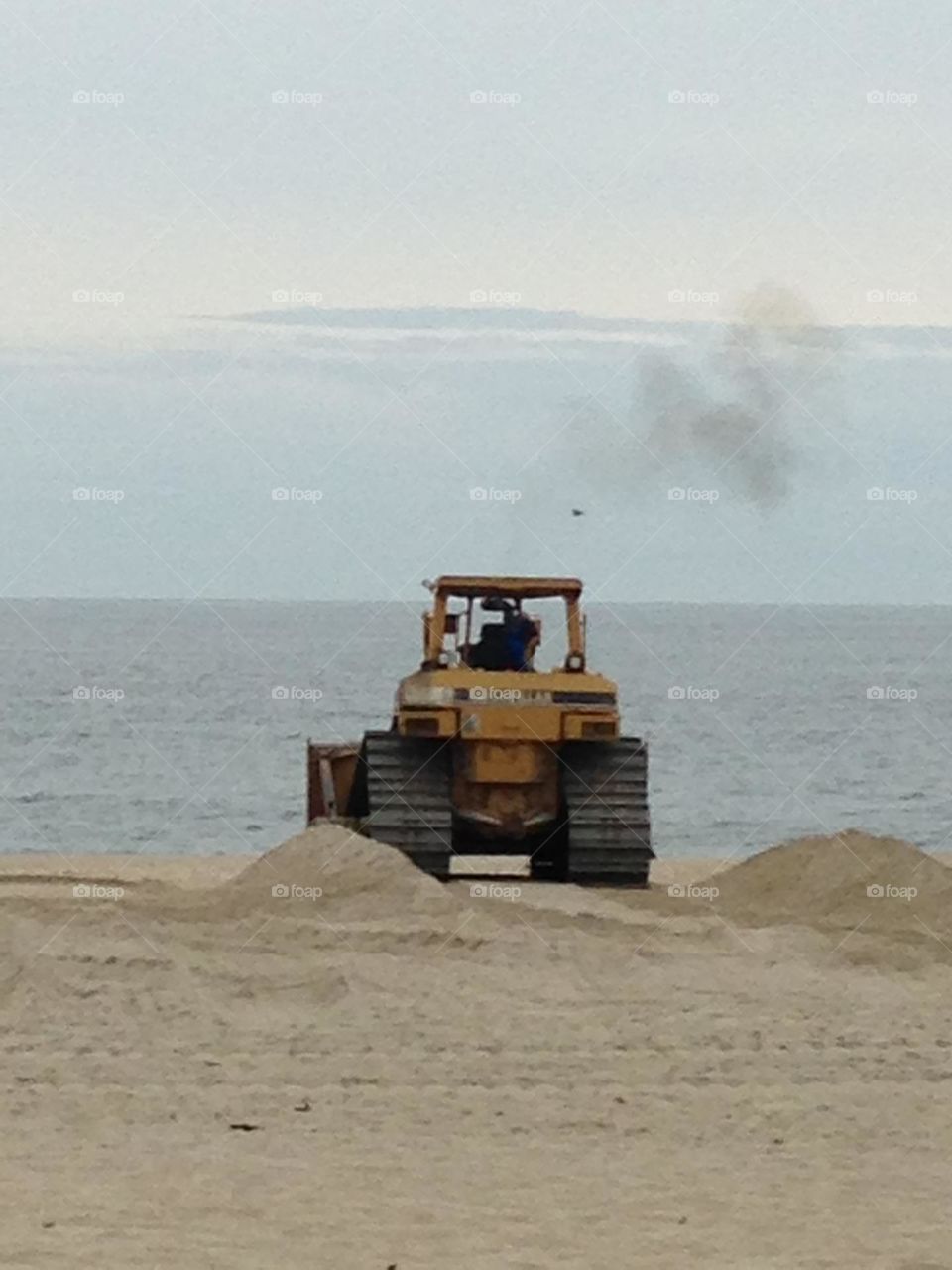 A man in a bulldozer works on the beach in May in preparation for the summer season in Point Pleasant Beach, NJ. 