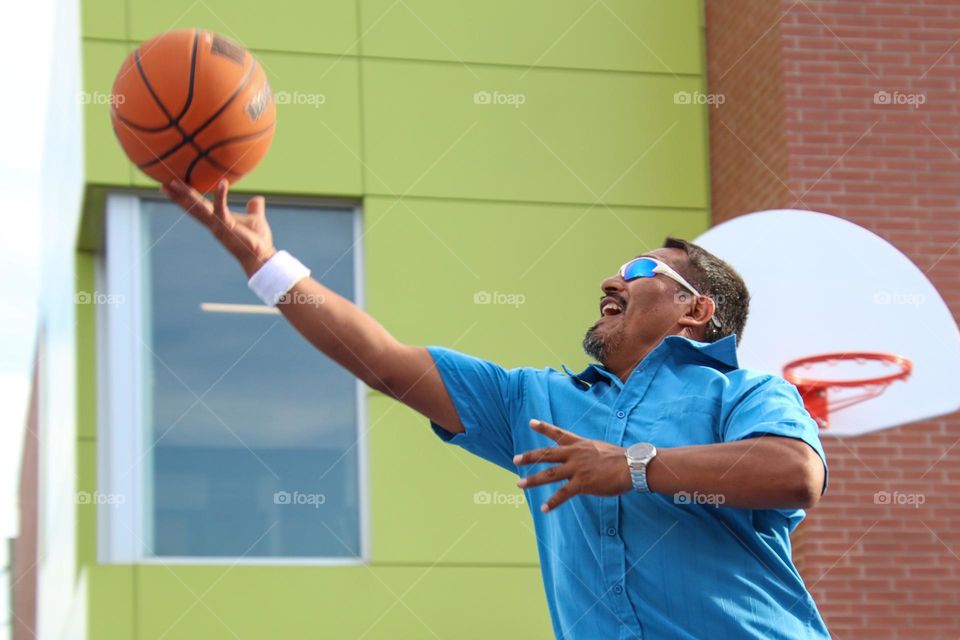 Middle-aged man is playing basketball