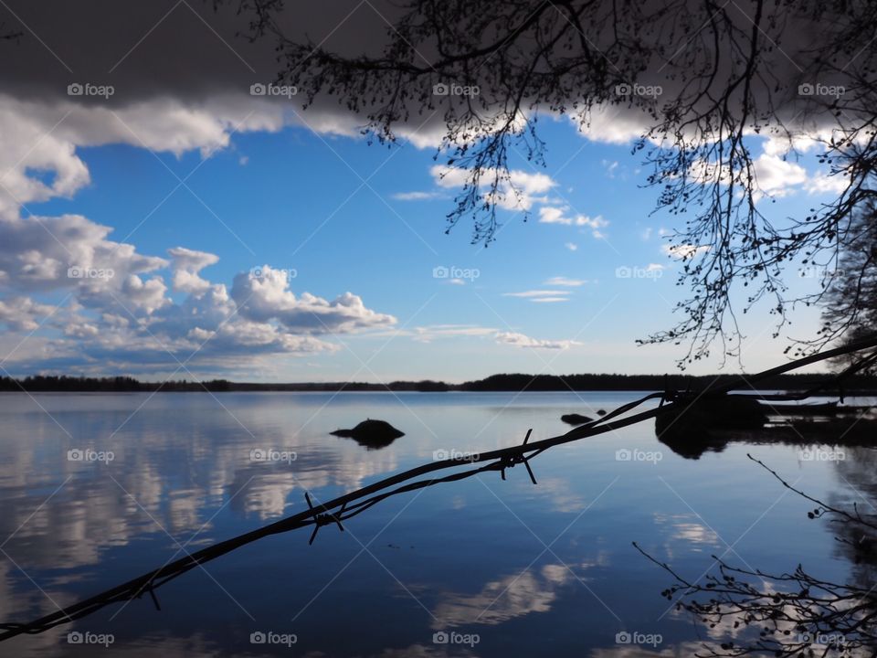 Beautiful white and blue landscape from Finland. Barbed wire goes through a stunning view.