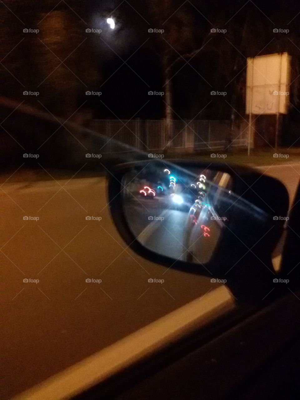 car in the mirror at night