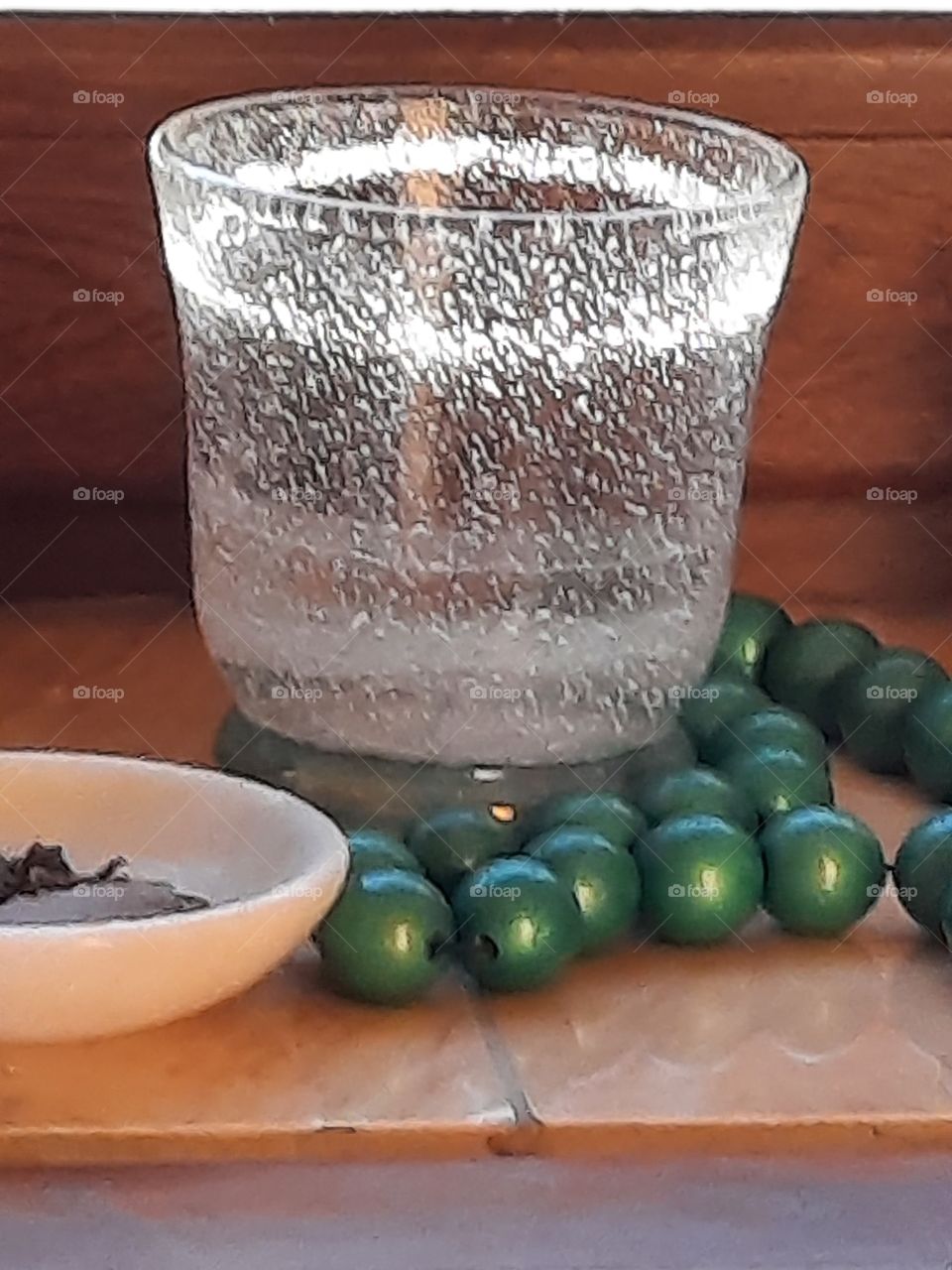 party sunlit glass with green wooden beads