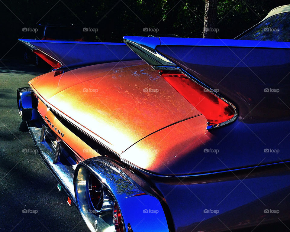 Shiny reflective chrome and large fins on a vintage American car