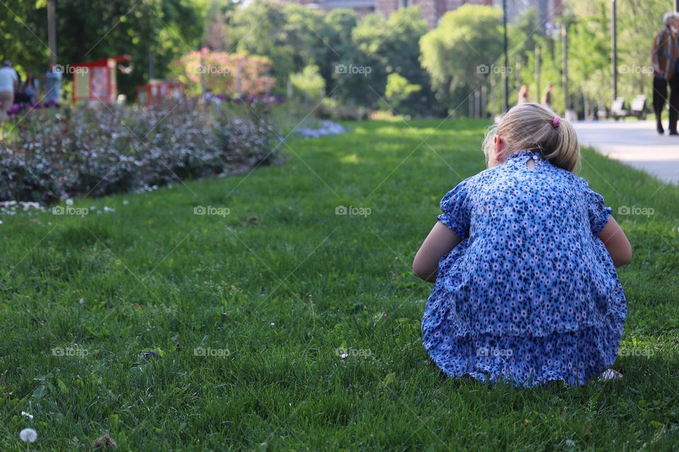 Spending time at the nature - Child picking a flower