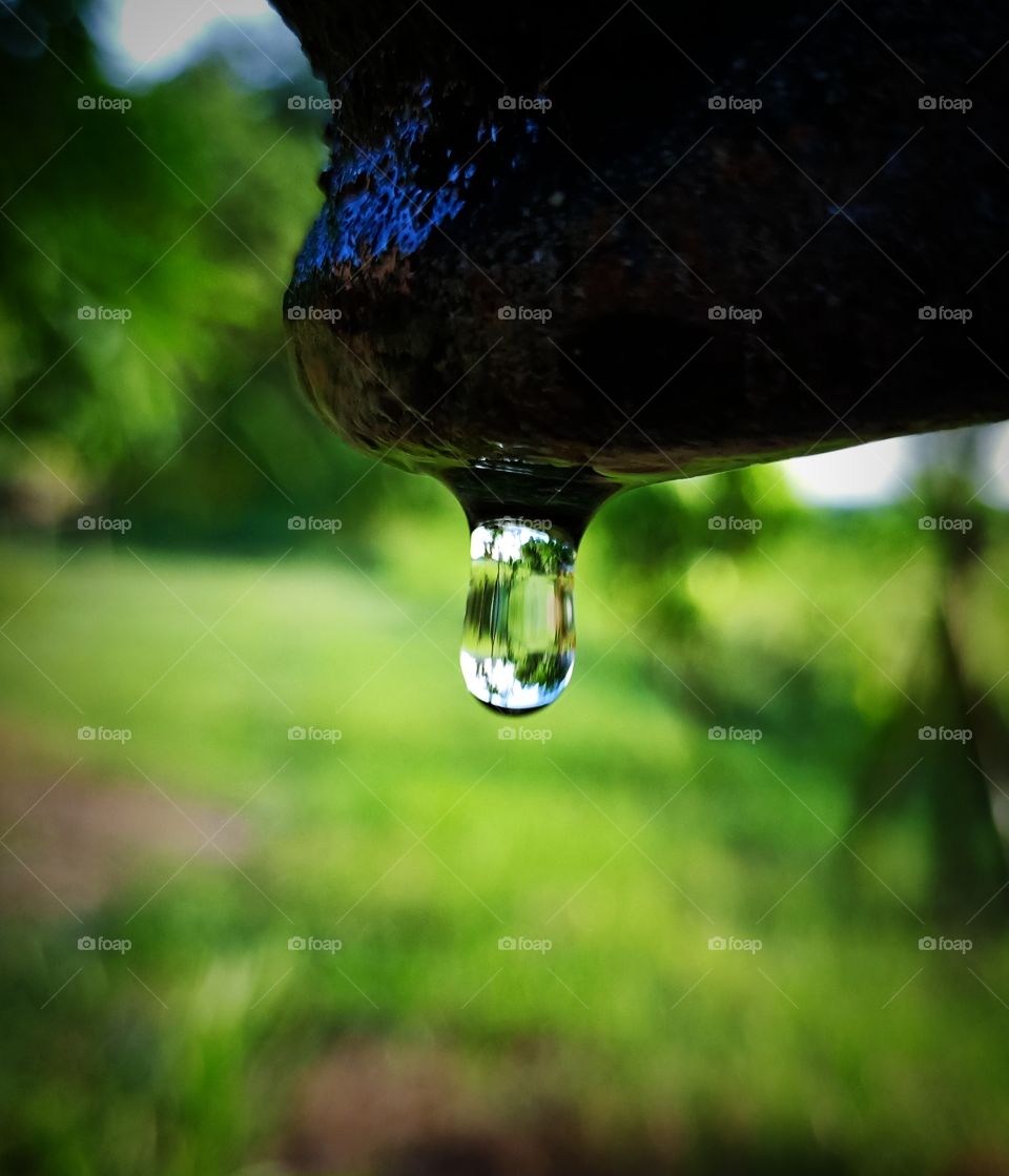 A drop of water dropping from tap