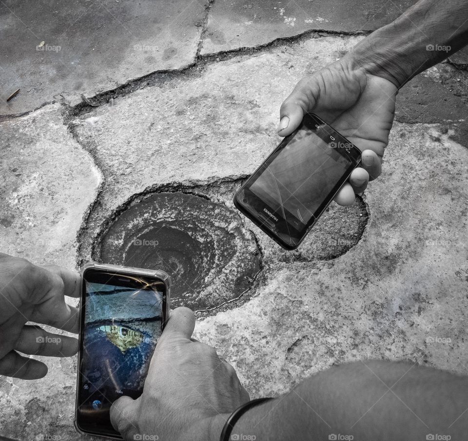 Bagan/Myanmar-April 16 2019:People take Reflection photo of beautiful Shwezigon Pagoda in the puddle