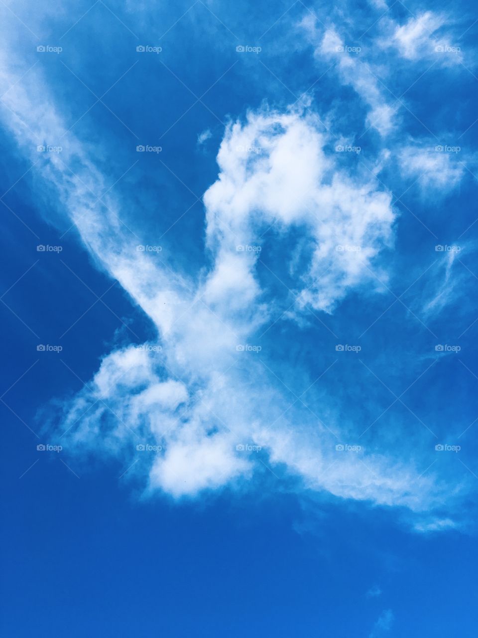 Clouds hug the blue clear sky 