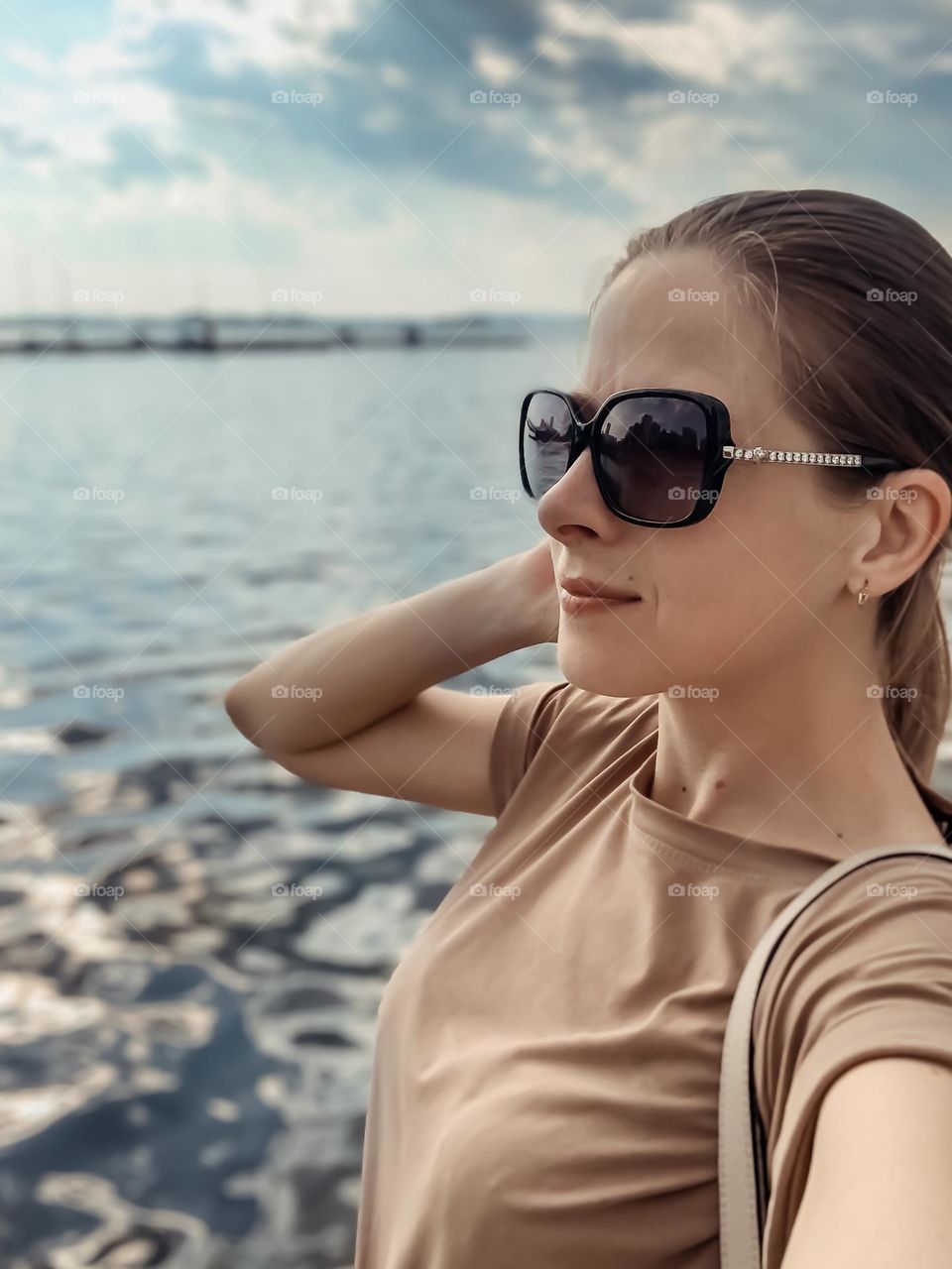 portrait of a girl on the background of water, summer