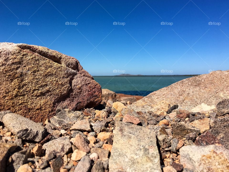 Peek a book view of ocean from rocks on cliff in south Australia 