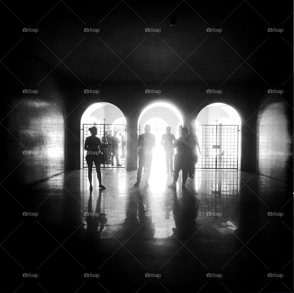People's silhouette in a tunnel illuminated 