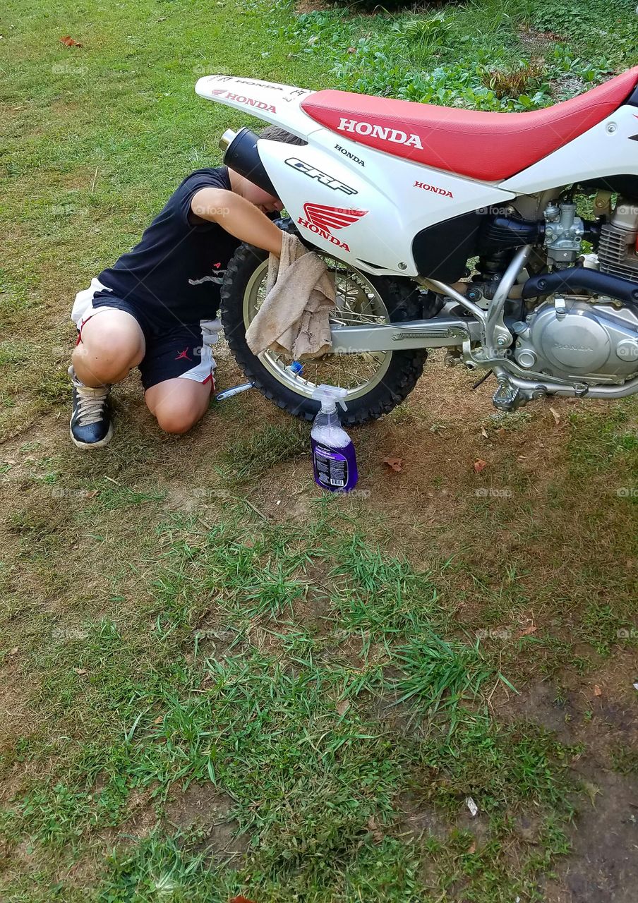 my son cleaning dirt bike