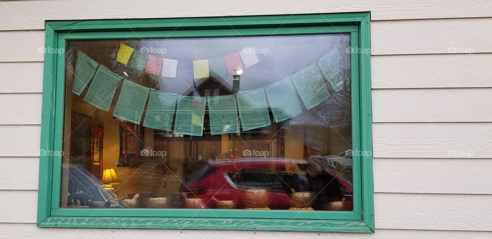 prayer flags through window