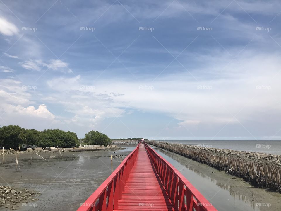 Red bridge beside sea