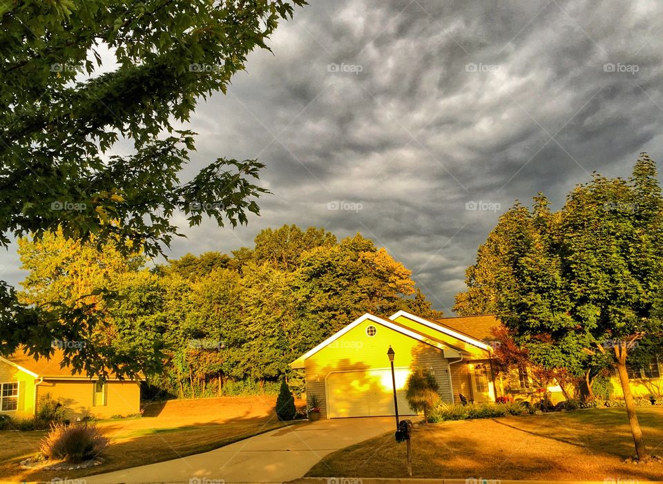 Sunlight on modern house against cloudy sky