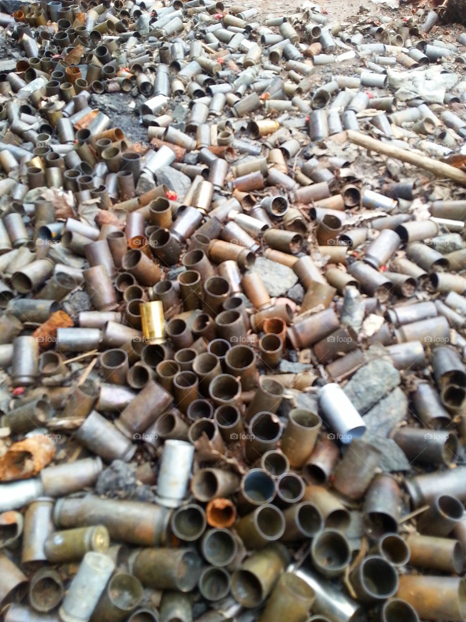 Gunfire bullet shell remnants. scattered on the gun range grounds, serious ammo