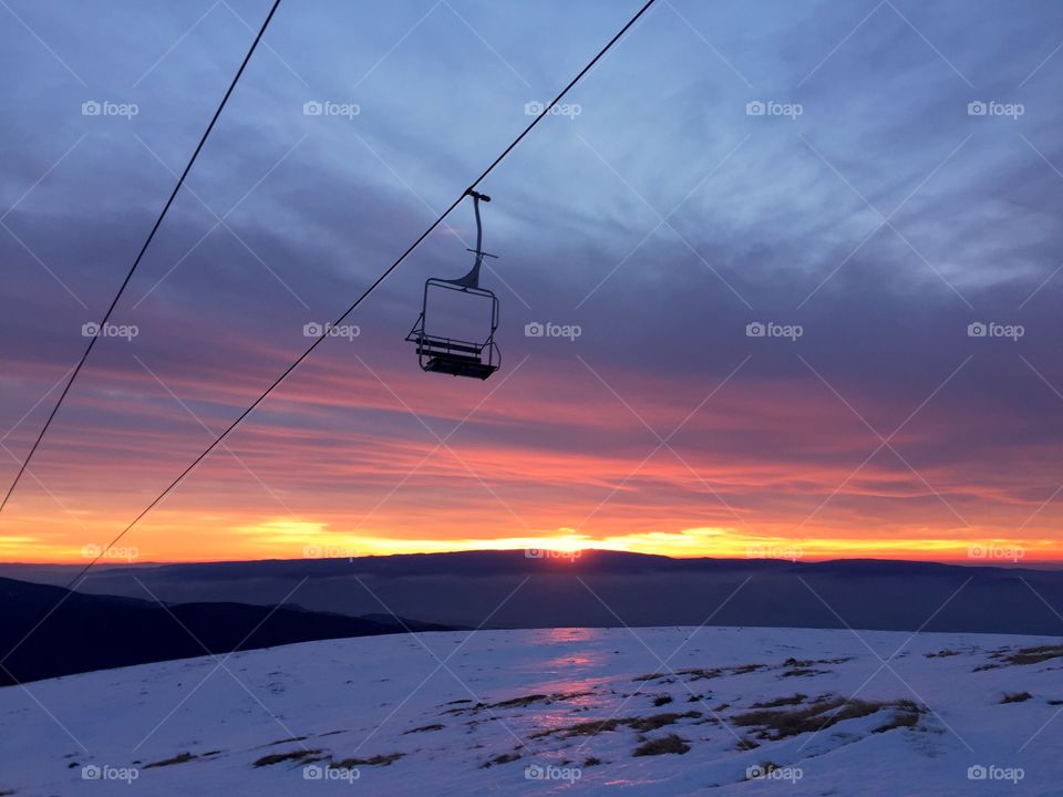 View of snowy landscape at sunset