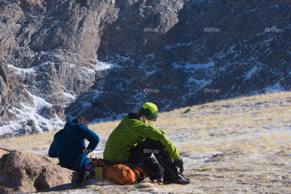 Men taking a break while climbing mountain in Colorado.