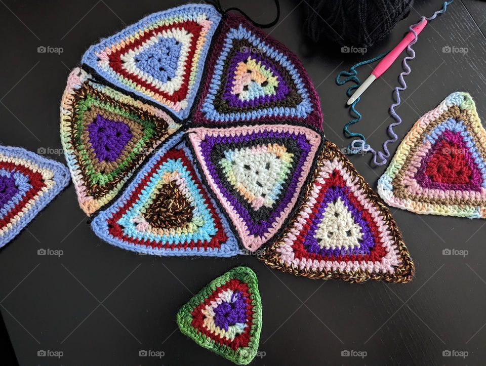 they may not be perfect but these are granny square Triangles instead of a square. I'm crocheting a blanket using scrap yarn.