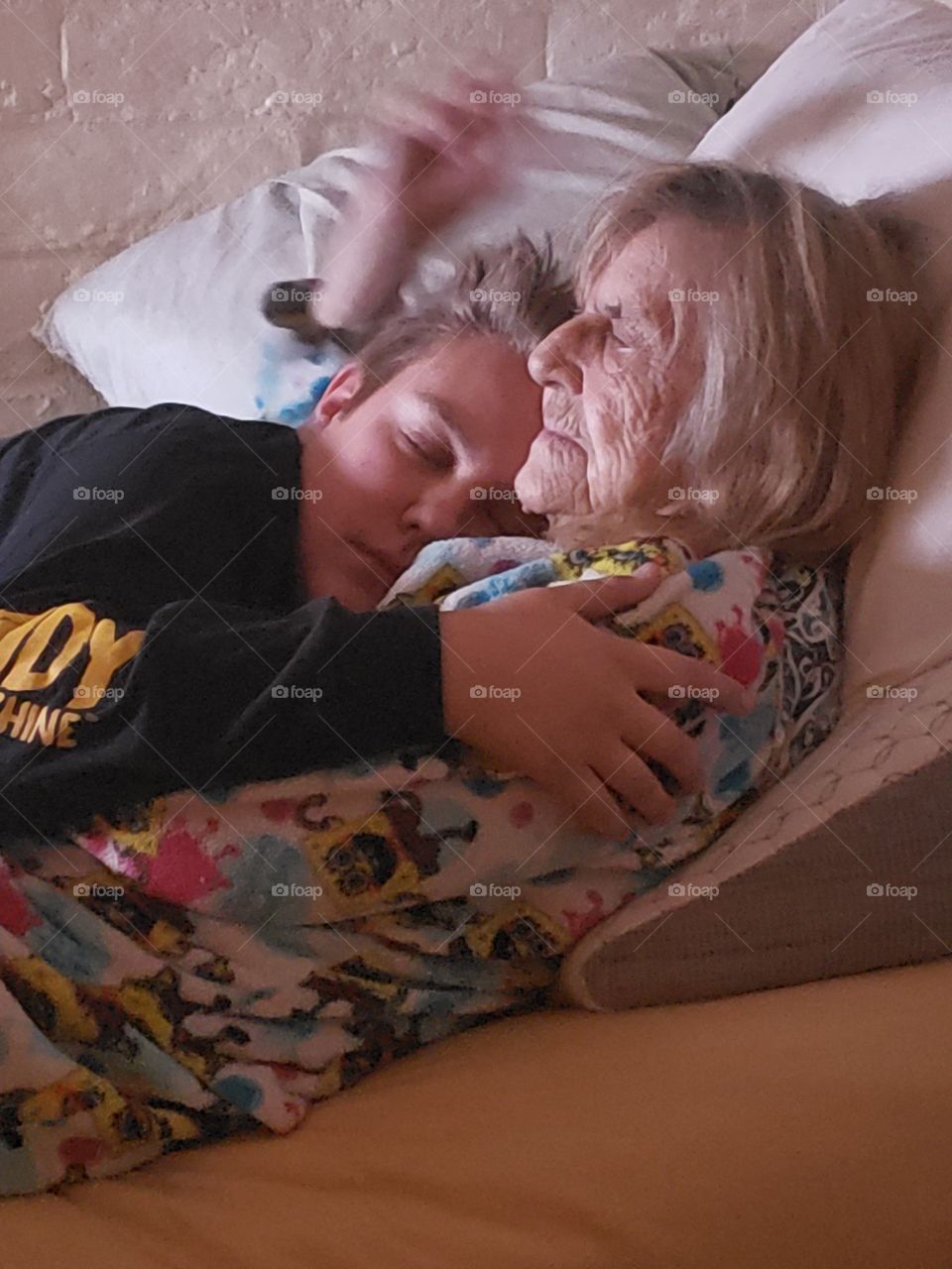 grandma and grandson laying arm and arm. 88 years young and a 15 years young. Love during this holiday season with a great gift of my mom visiting our new home. This the season..