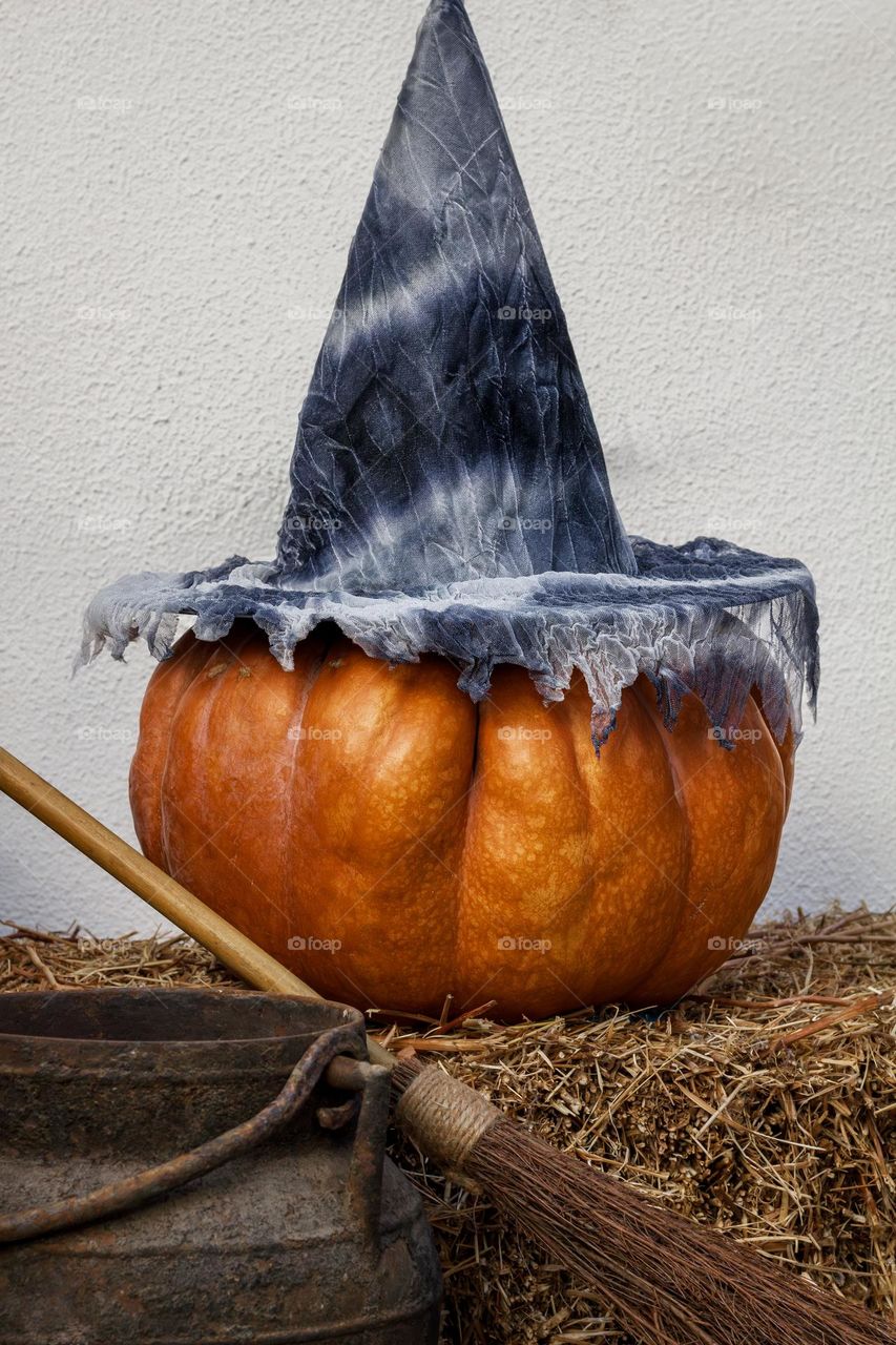 Pumpkin in witch’s hat with broom & cauldron