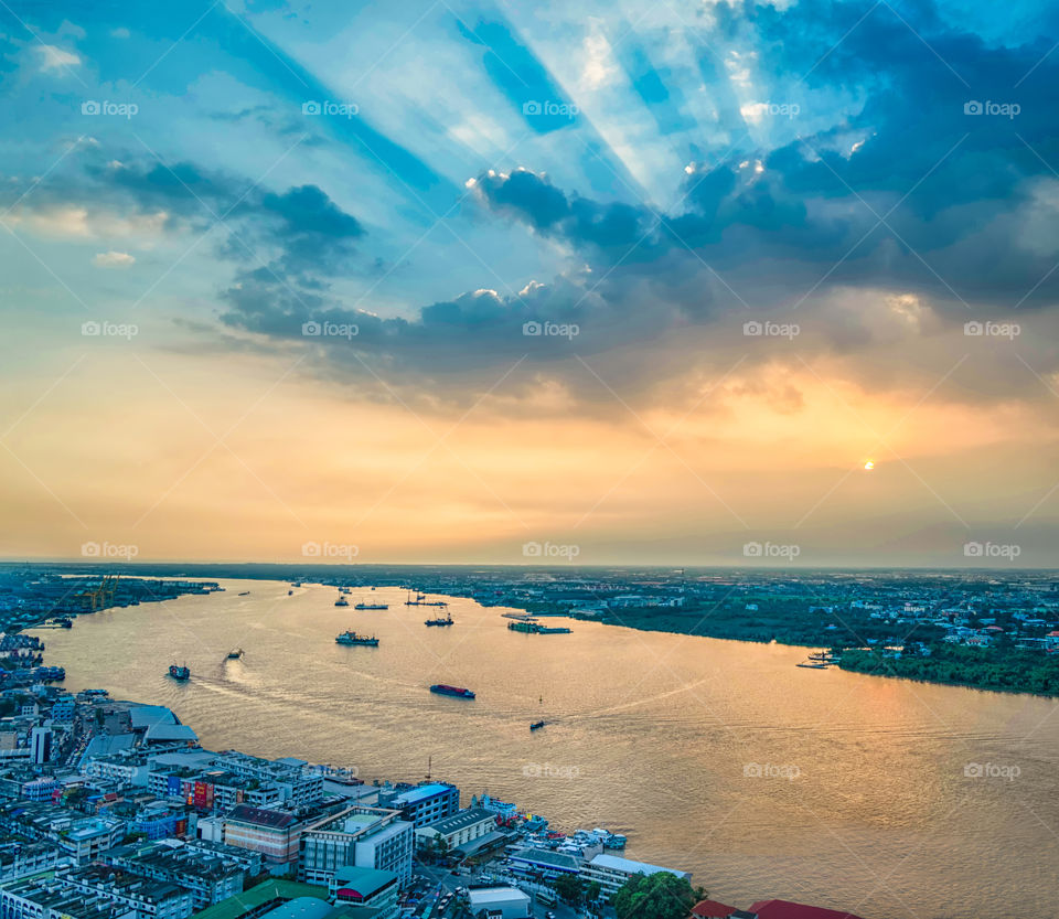 Bangkok city scape and boat in the river with beautiful sky background