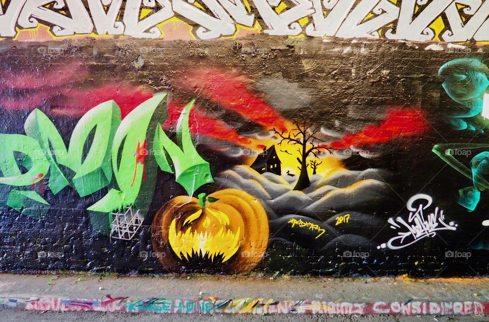 Halloween theme spray painted mural graffiti in the Leake Street tunnel in London.