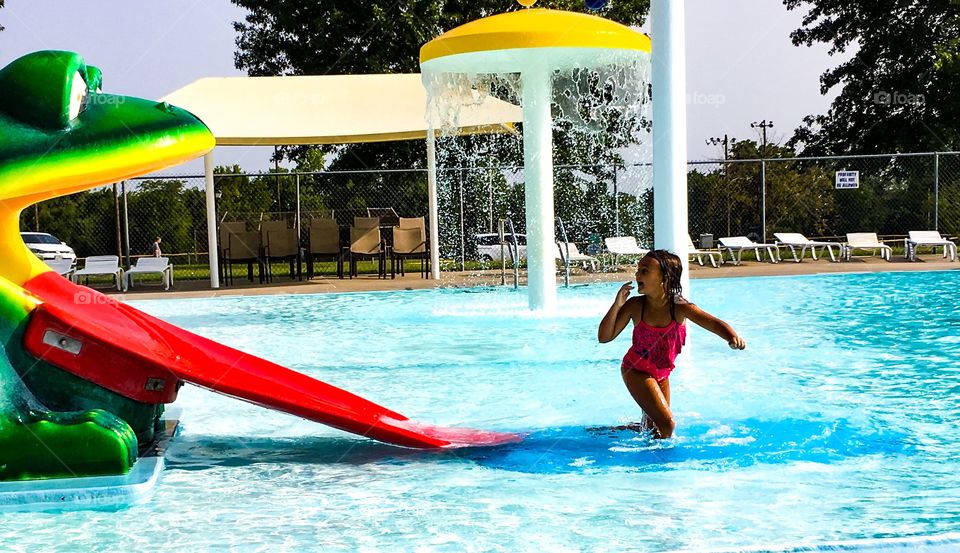 My daughter at the pool near the frog slide.