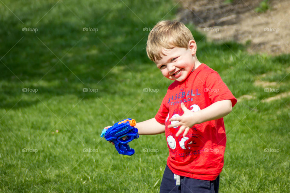Cute child with water gun