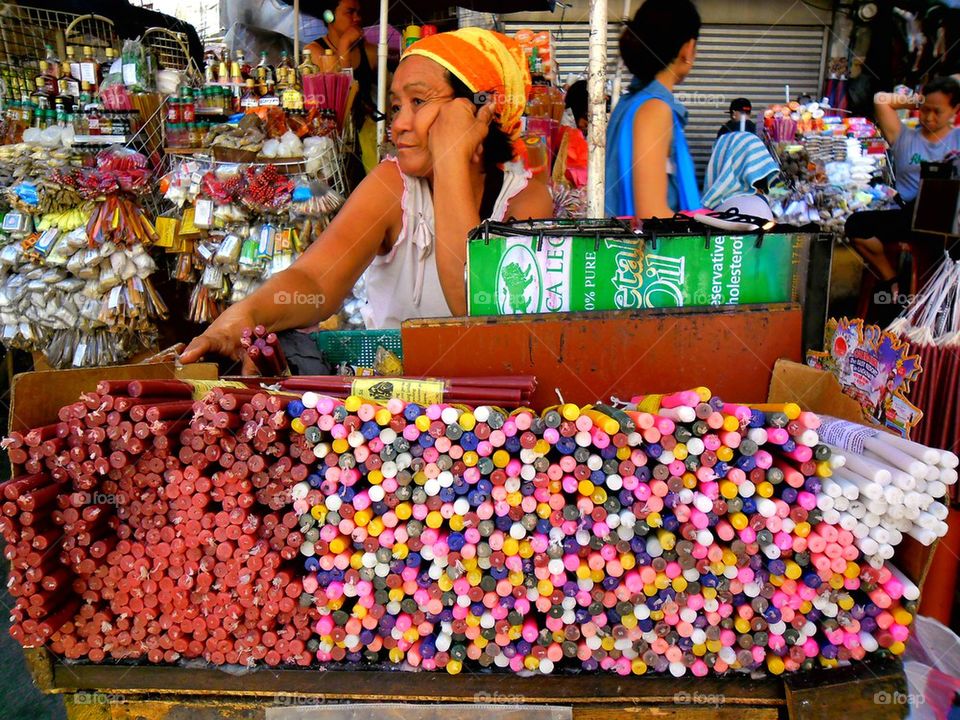 asian street vendor selling candles outside quiapo church in manila, philippines, asia