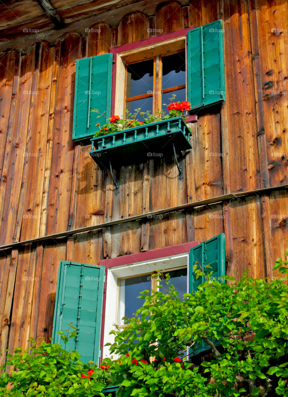 Traditional Austrian building . Traditional Austrian building exterior, beautiful windows and flowers, Hallstatt, Austria, Europe 