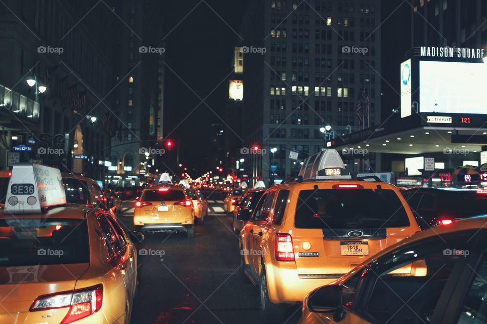 Riding through the city slow. Yellow cab traffic at Madison square garden, NYC. 