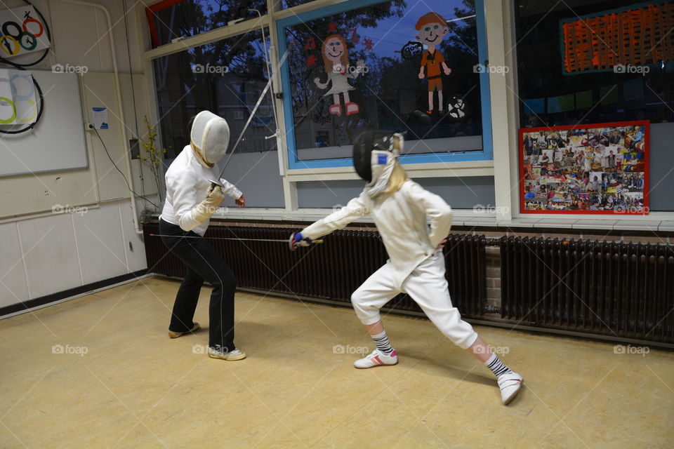 Two girls fencing