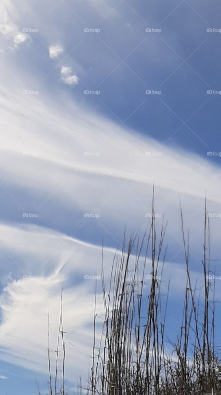 white clouds over beach sea boats deep blue sky and water