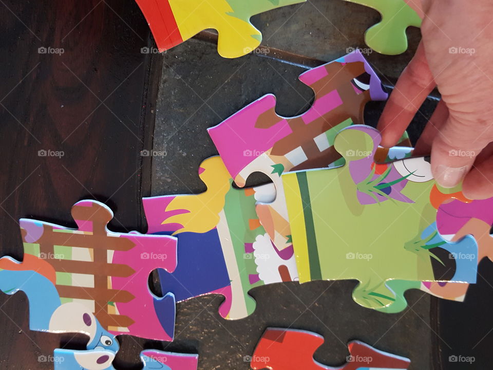 Close-up of human hand with puzzle pieces